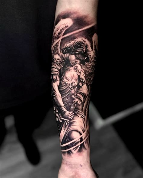 A Black And Gray Saint Michael Tattoo Is A Dramatic And Highly Detailed Piece That Portrays The Archangel In His Iconic Battle Against Evil Saint Michael Is Typically Depicted As A Powerful