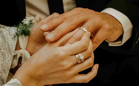 Two People With Wedding Rings On Their Fingers